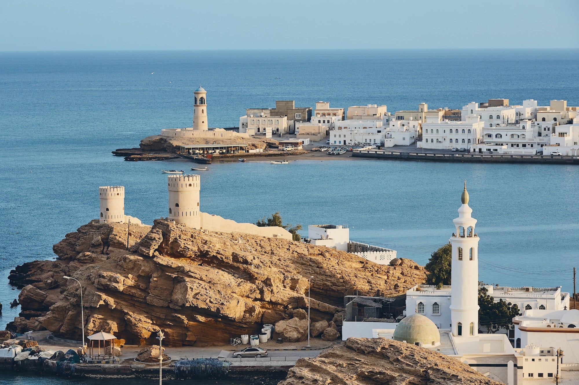 Lighthouse, watchtowers and white houses of traditional architecture of old town Sur in Oman