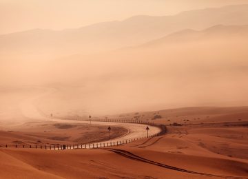 Desert empty road in the foggy weather. Empty Quarter in Abu Dhabi emirate, UAE